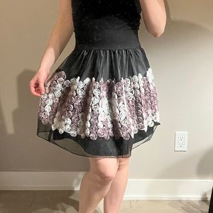 A line mini skirt with rose appliqués